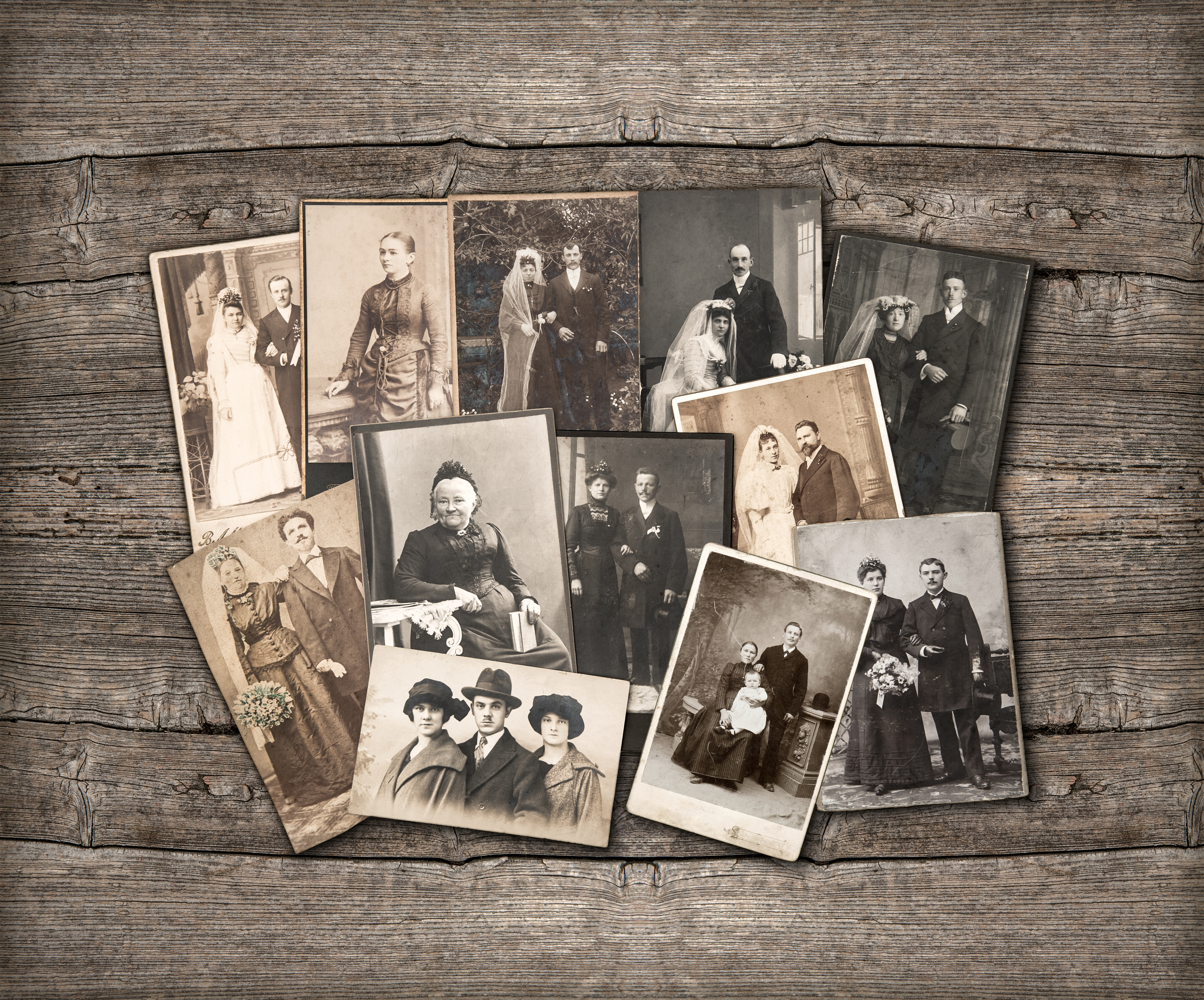 group of vintage family and wedding photos circa 1890-1920. nostalgic sentimental pictures on rustic wooden background